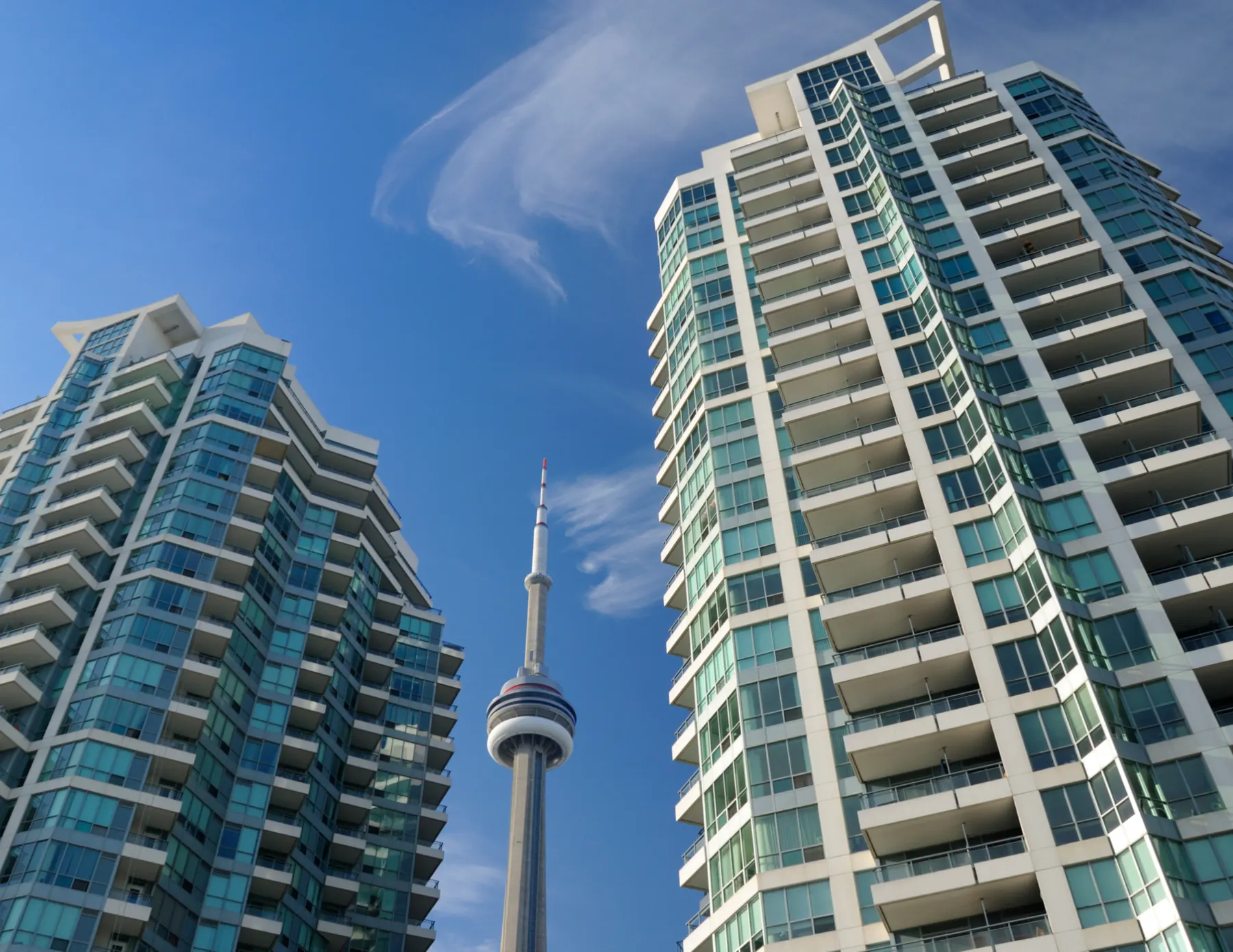 Two residential high-rise towers against a blue sky